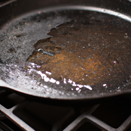 A cast iron skillet being seasoned with oil in the oven.